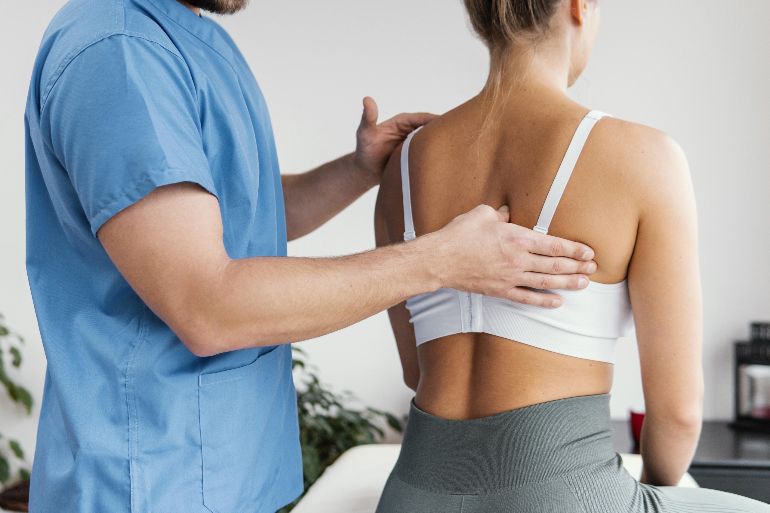 side-view-male-osteopathic-therapist-checking-female-patient-s-scapula-bone